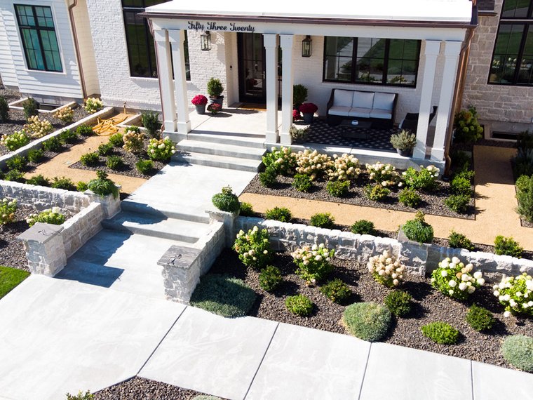 Aerial view of a paver patio and planting beds installed by B&K